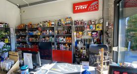 Wnętrze sklepu motoryzacyjnego Auto-Parts z widocznym asortymentem części samochodowych 